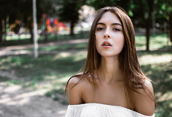 Naklejka premium Portrait of beautiful sexy girls with dark hair and bare shoulders seductively in park