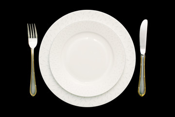 Plate and cutlery.  Isolated, black background.