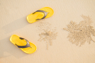 yellow sandals on the beach at the vacation or relax time