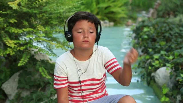 Happy child listening to music in nature