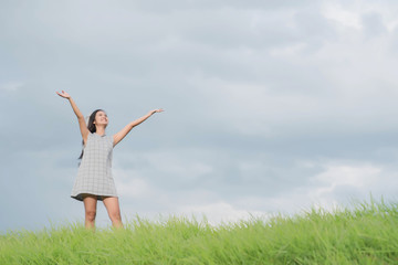 Naklejka na ściany i meble Carefree woman having a good time at the meadow