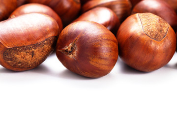 Group of grilled chestnuts. Isolate on white background. Autumn background.