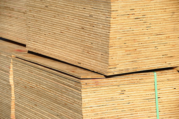 stacking plywood in construction site, construction materials