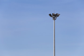 Circular Spotlight Pole on blue sky background.