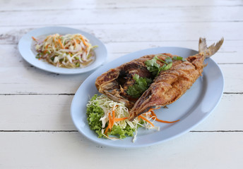 Fried Seriola fish in blue dish.