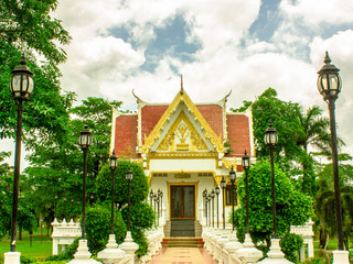 Thai temple and cloudy sky in sun shine.