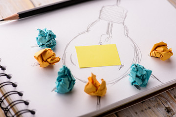 Inspiration concept crumpled paper with light bulb metaphor for