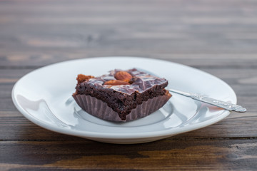 Homemade chocolate brownie with almond on wood table