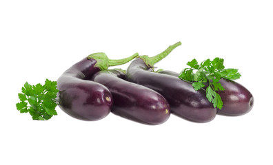 Several eggplants and parsley sprigs on a light background