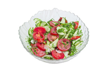 Salad with fresh sliced tomatoes and cucumbers on light backgrou