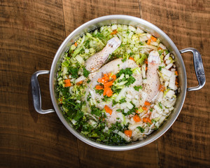 Chicken soup ingredients in cook pot