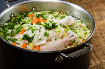 Chicken soup ingredients in cook pot