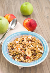 Vertical making a bowl with cereal with fruit pieces