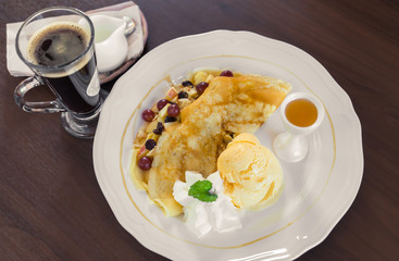 Pancake and fruit with ice cream on table