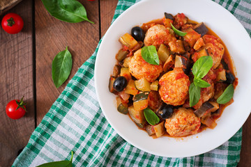 Juicy meatballs of turkey meat with vegetables (zucchini, eggplant, olive, tomato). Top view