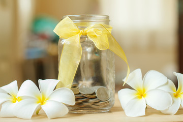 glass piggy bank with sunset light in saving money concept and f