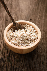 organic millet in a wood bowl on wooden rustic table