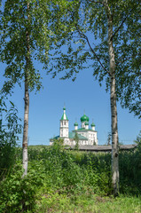 Old Russian Church on a background of birch trees