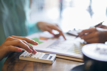 image of young women discussing a project in coffee shop
