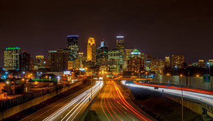 Light  streaks under the Minneapolis skyline - obrazy, fototapety, plakaty