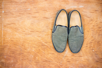 Green old shoes on wooden floor