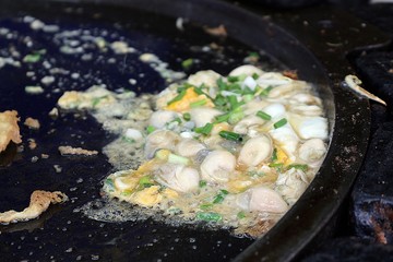 Oyster omelette / Asian style cooking soft oyster omelette in big black pan