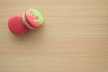 Colorful france macarons on wooden desk background.