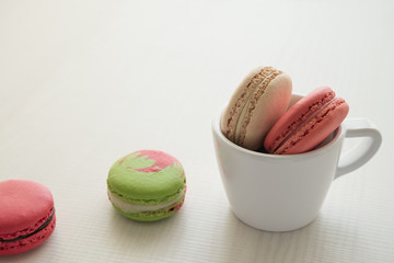Colorful france macarons on white background.