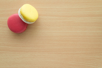 Colorful france macarons on wooden table background.