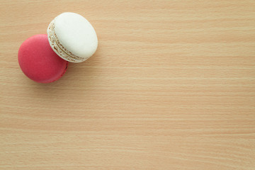 Colorful france macarons on wooden table background.