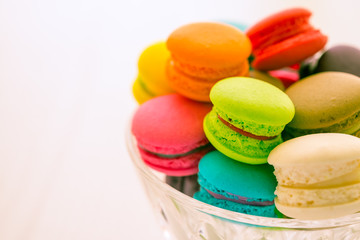 Colorful france macarons on glass cup.
