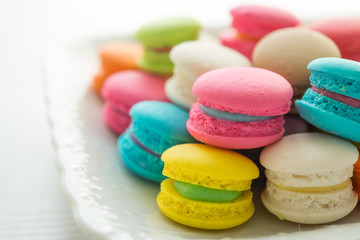 Fototapeta na wymiar Colorful france macarons on white vintage dish.