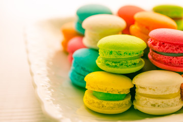 Colorful france macarons on white vintage dish.