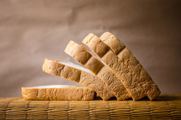 Bread wheat slice on brown background, testy organic food