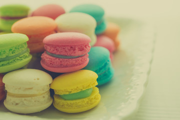 Colorful france macarons on white vintage dish - retro color tone