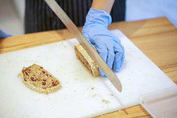 Woman Slicing Mixed Grain Bread
