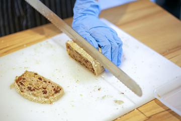 Woman Slicing Mixed Grain Bread

