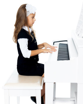 Girl sitting at the piano