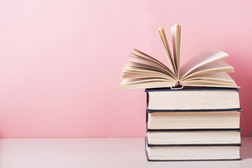 Open book, hardback books on wooden table. Education background. Back to school. Copy space for text.