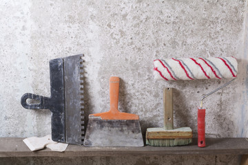 Construction tools on concrete background. Copy space for text. Set of assorted plaster trowel and spatula