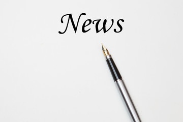 Fountain pen on news text