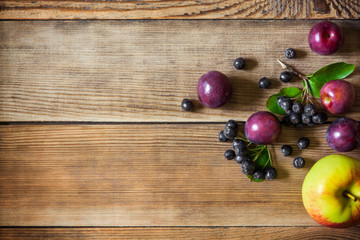 Summer fruits on wooden background in rustic style. Top view.