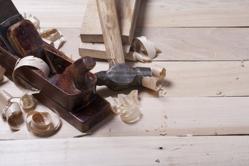 Construction tools on wooden table with sawdust. Joiner carpenter workplace top view. Copy space for text