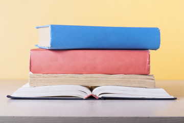 Open book, hardback books on wooden table. Education background. Back to school. Copy space for text.