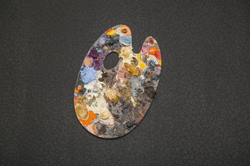 Artist's palette with multiple colors isolated on black