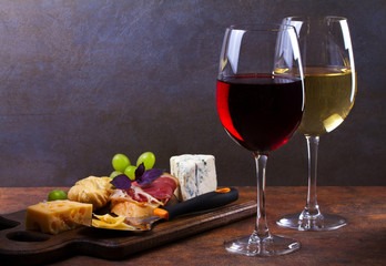 Red and white wine. Smoked cheese, grape, prosciutto, garlic and bread