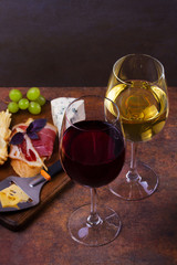 Red and white wine. Smoked cheese, grape, prosciutto, garlic and bread