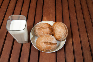 glass of milk standing on old wooden table