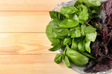 Bunch of fresh basil on wooden table