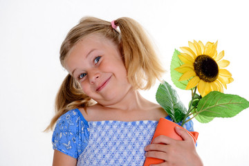 little smiling girl with pigtails and sunflower